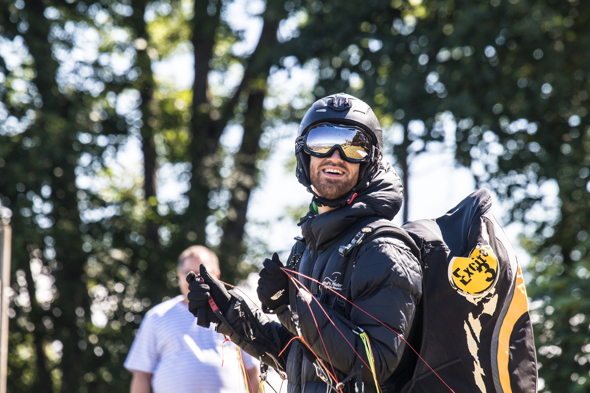 Person wearing a helmet and specialist equipment outdoors