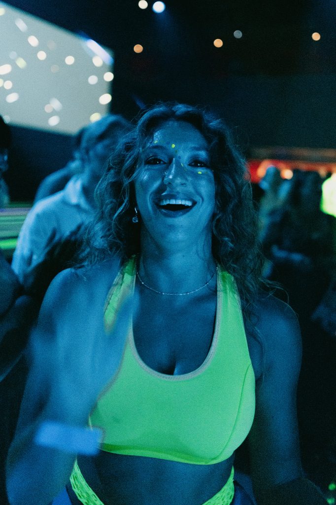 Smiling performer lit by deep blue stage light