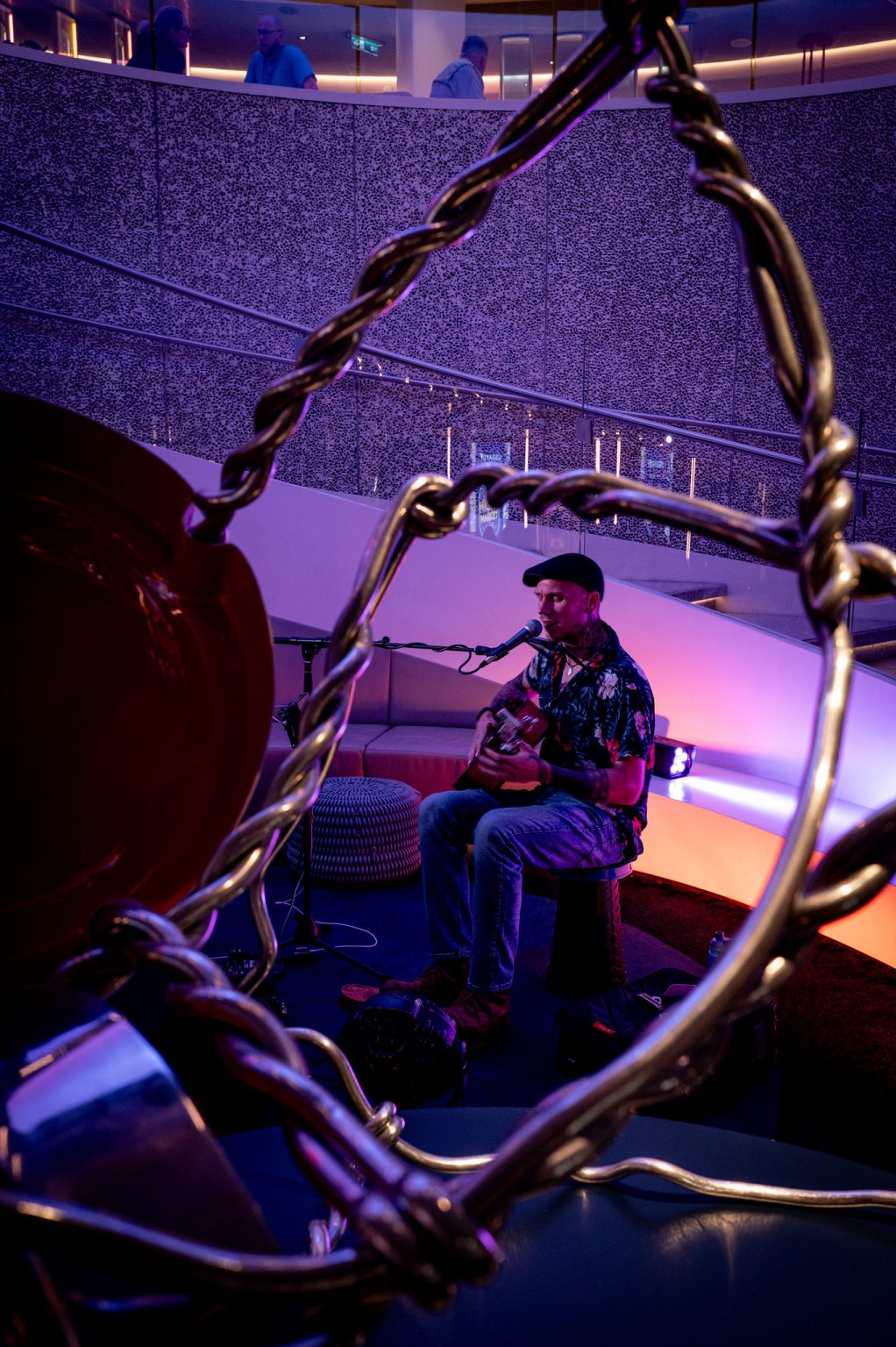 Aerial performer seated inside a suspended hoop