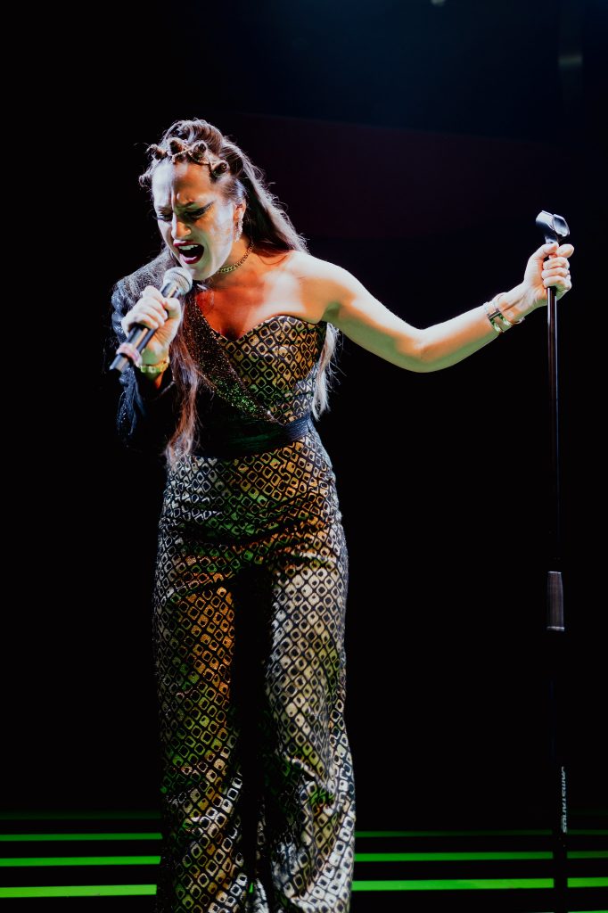 Female singer performing in a sequined dress