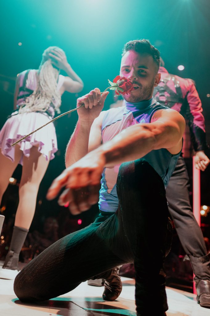 Male dancer kneeling during an energetic routine