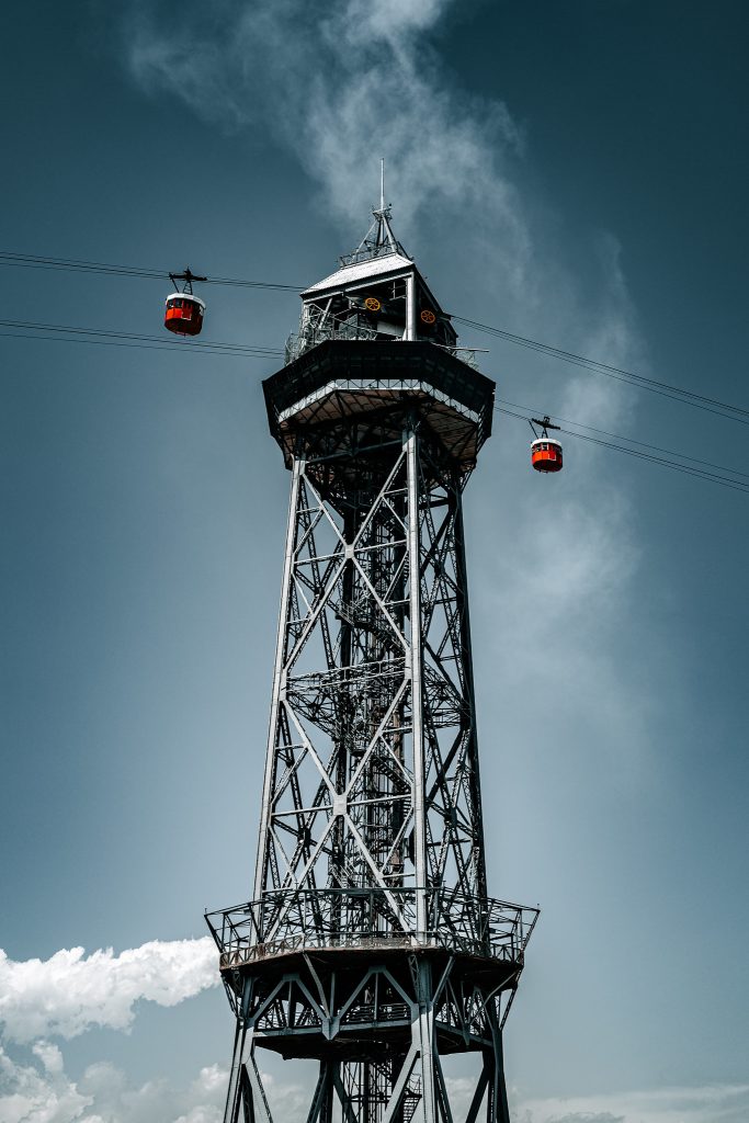 Cable-car tower rising into dark clouds