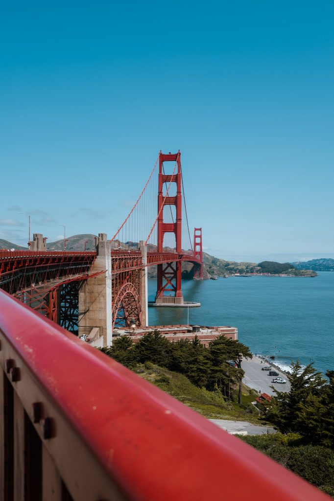 Golden Gate Bridge viewed from a red waterfront railing