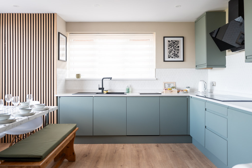 Pale blue accessible kitchen with low work surfaces