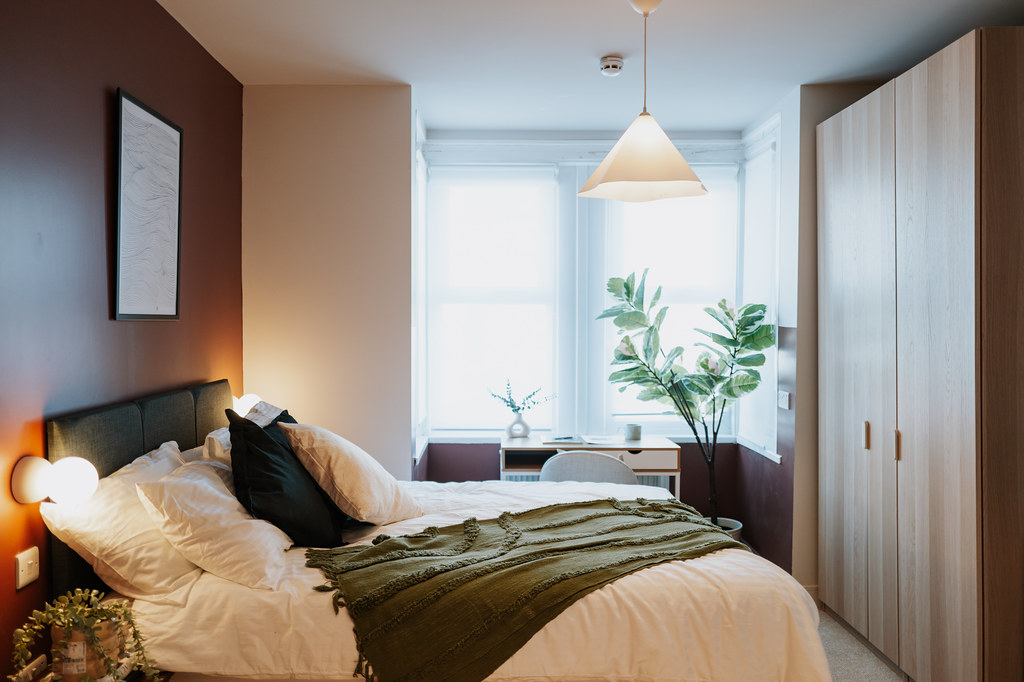 Compact bedroom with fitted wardrobes and a window seat