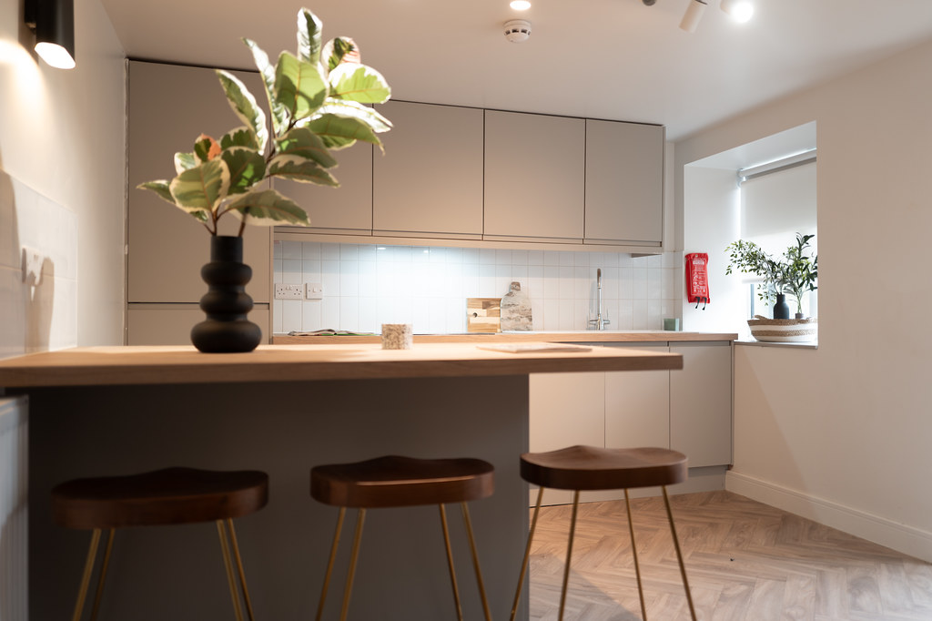 Compact kitchen with breakfast bar and three stools