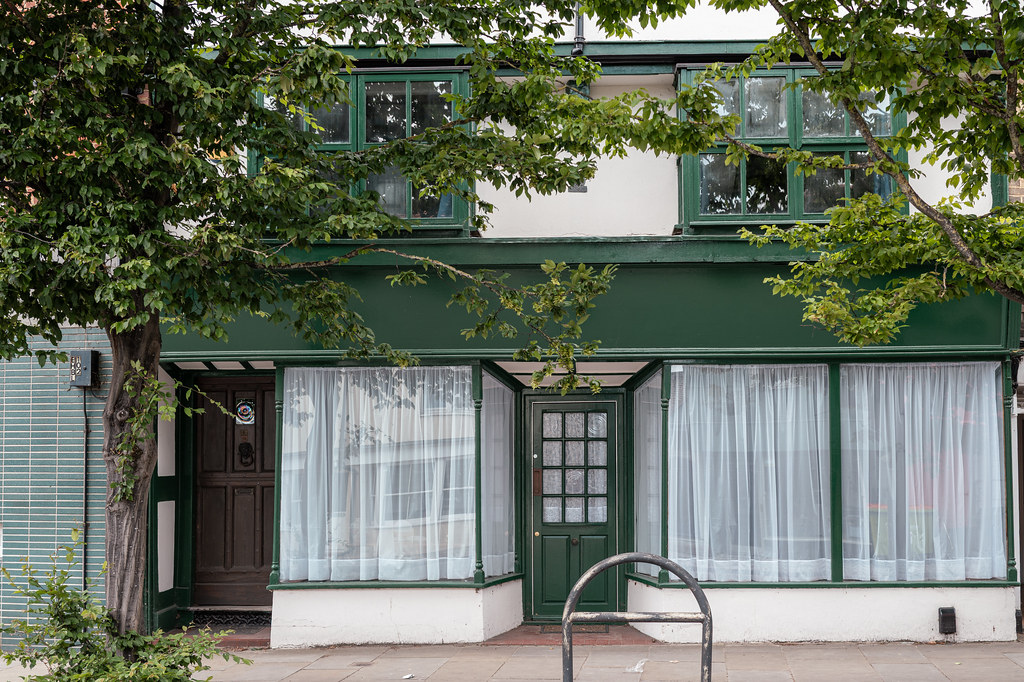 Green-painted frontage of a historic converted shop